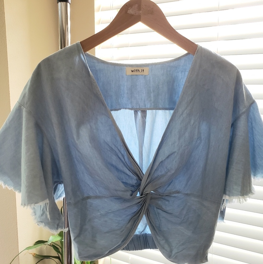 Trendy distressed crop top with statement sleeves